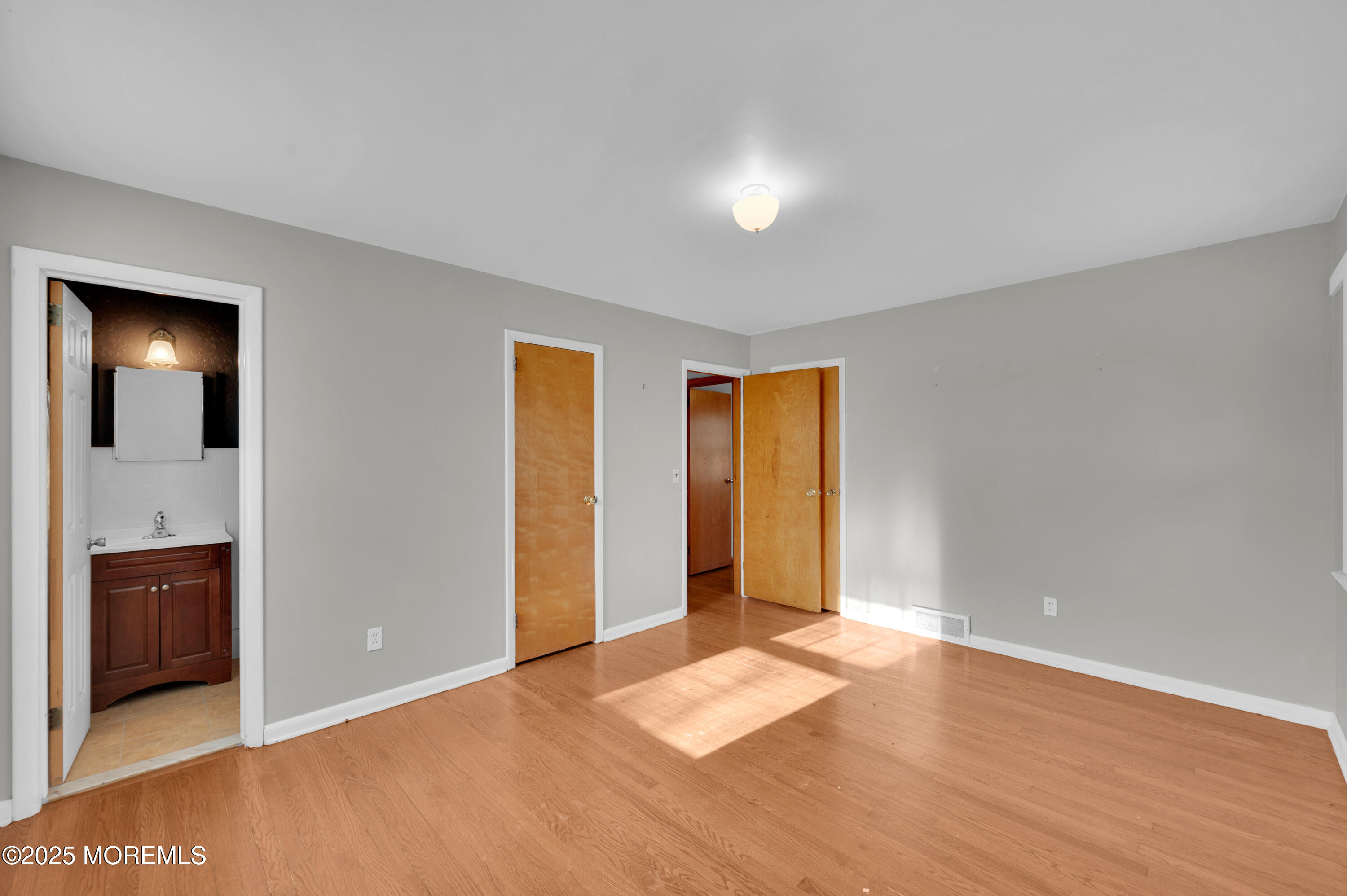 920 Ridge Road Brick, NJ 08724 - Photo 19 of 36 a view of an empty room with wooden floor and windows