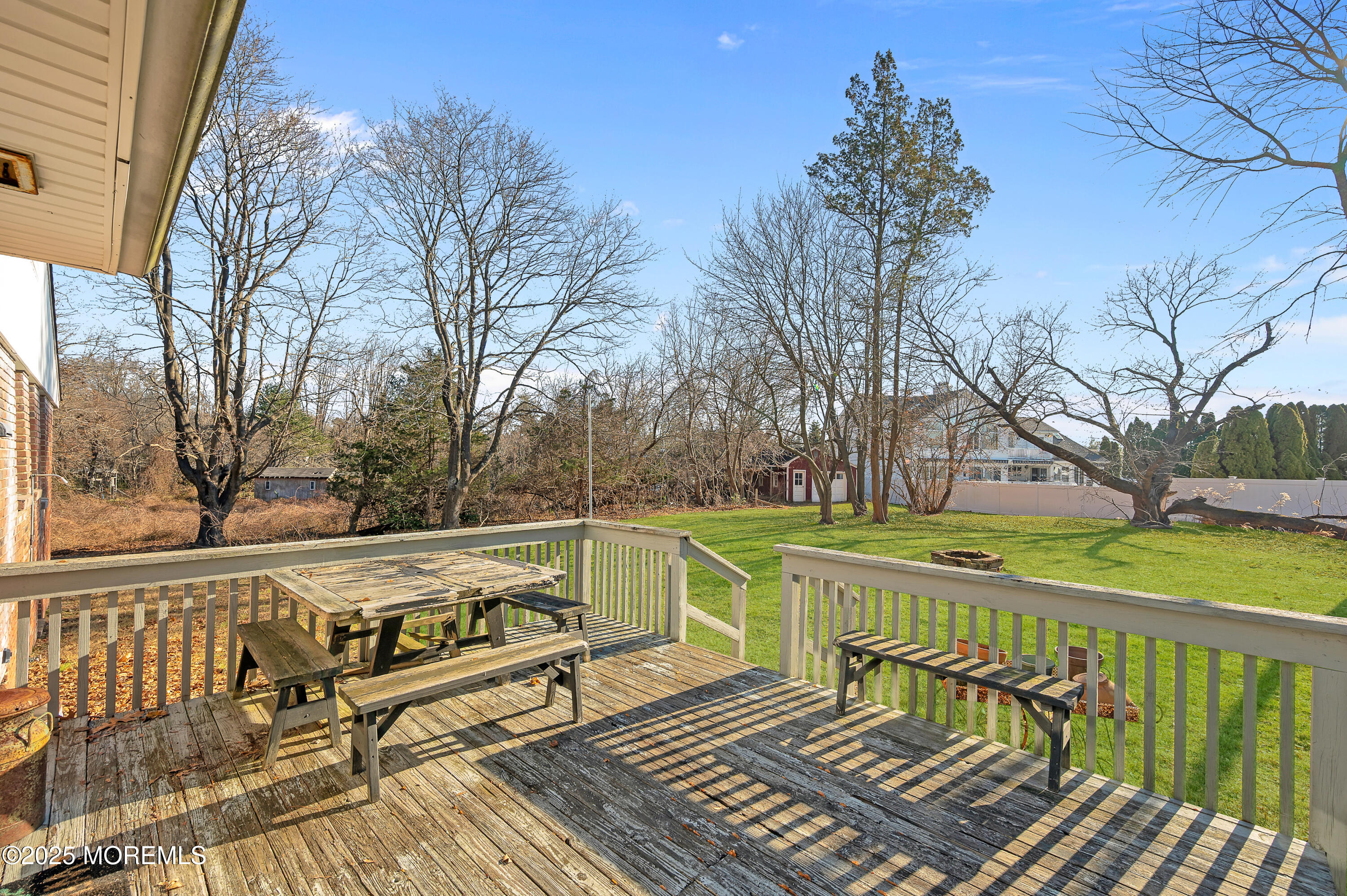 920 Ridge Road Brick, NJ 08724 - Photo 27 of 36 a view of a wooden deck with a bench and trees