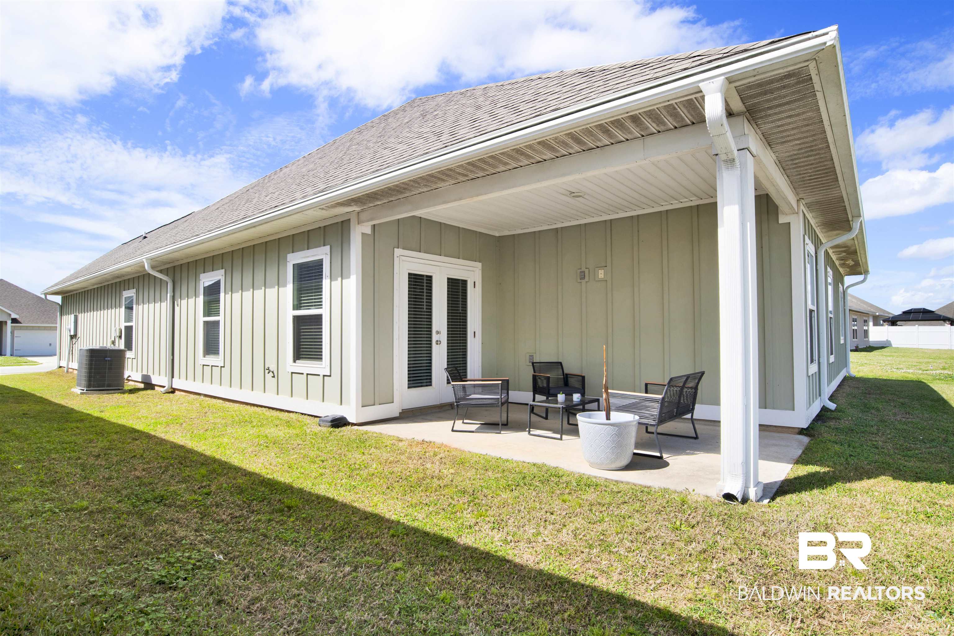 24253 Alydar Loop Daphne, AL 36526 - Photo 37 of 44 Back of house featuring a yard, board and batten siding, a patio, and roof with shingles