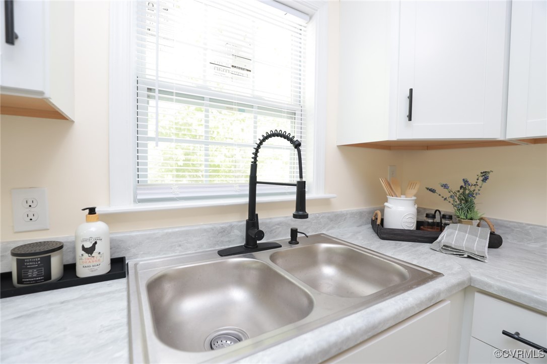 13077 Oral Oaks Road Victoria, VA 23974 - Photo 21 of 34 a kitchen with a sink a counter and a window