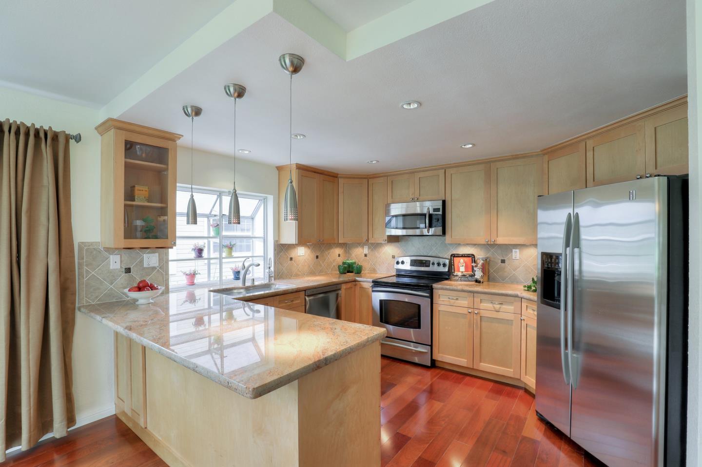 4 Muirfield Road Half Moon Bay, CA 94019 - Photo 11 of 40 a kitchen with granite countertop a sink stainless steel appliances and cabinets