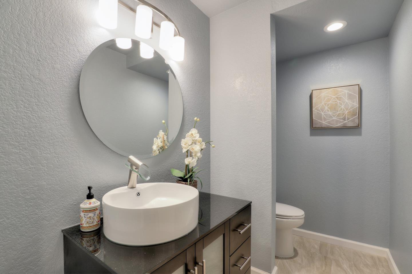 4 Muirfield Road Half Moon Bay, CA 94019 - Photo 19 of 40 a bathroom with a sink mirror and toilet