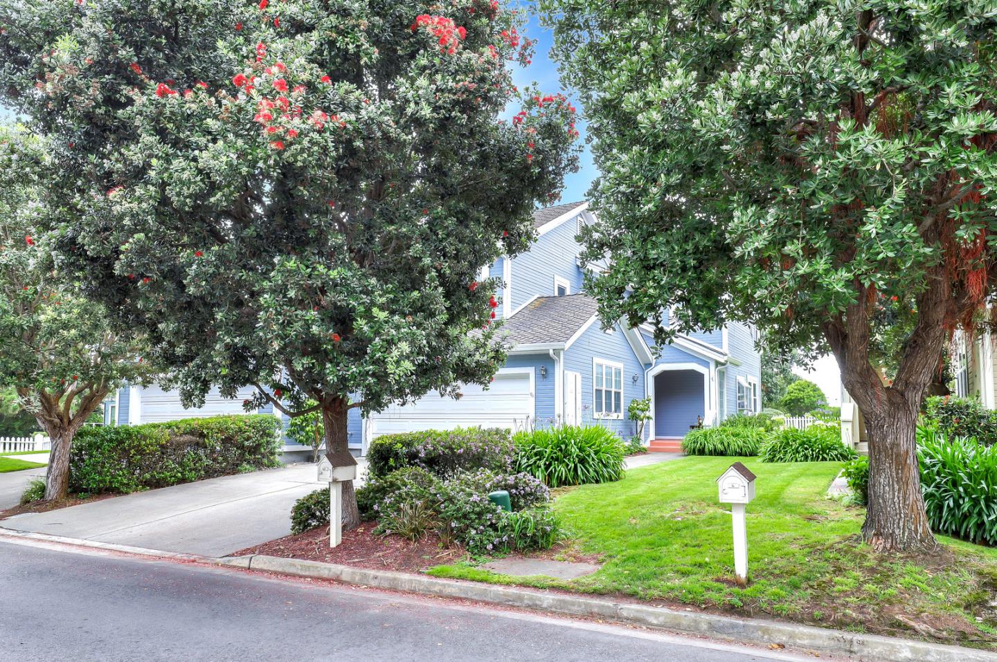 4 Muirfield Road Half Moon Bay, CA 94019 - Photo 6 of 40 a front view of a house with a yard and garage