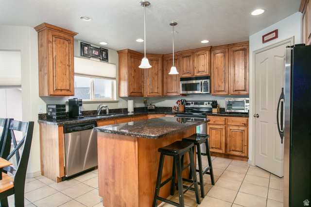426 Deer Hollow Road Tooele, UT 84074 - Photo 7 of 37 Kitchen featuring light tile patterned flooring, brown cabinets, stainless steel appliances, and recessed lighting