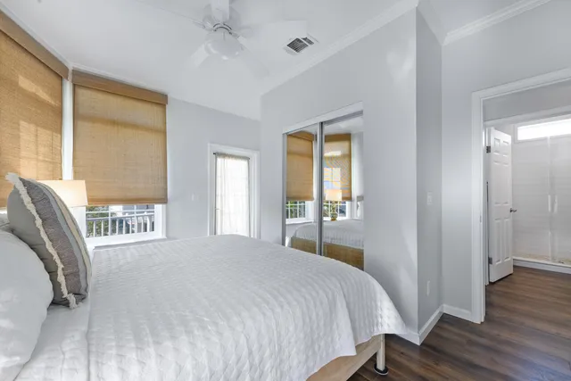 a bedroom with a bed and a large window