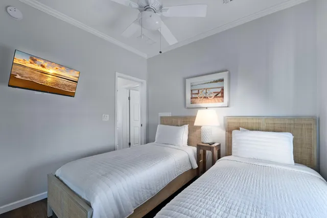 a bedroom with two beds and painting on the wall