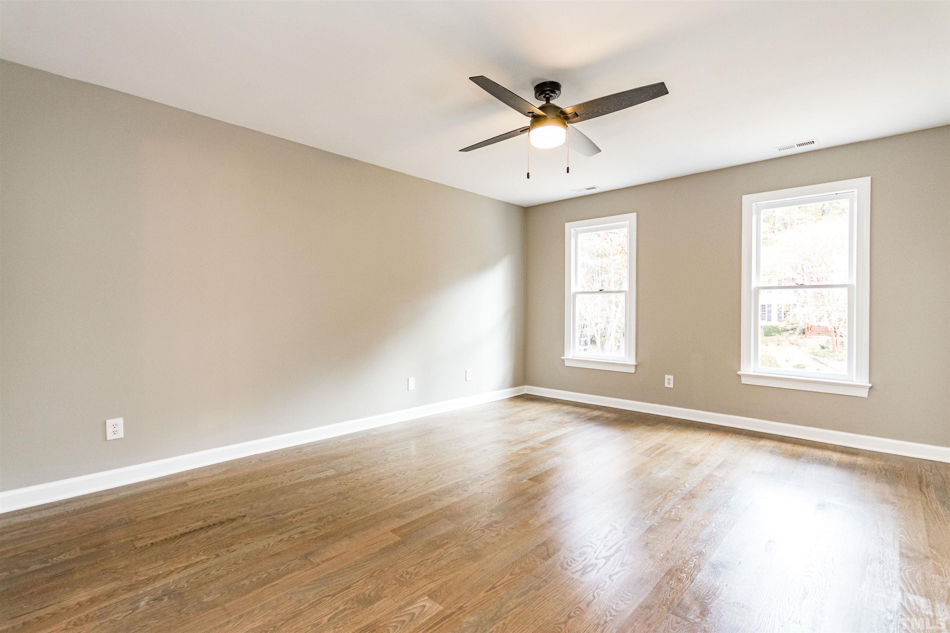 8105 Laurel Mountain Road Raleigh, NC 27613 - Photo 11 of 26 a view of a big room with wooden floor and windows