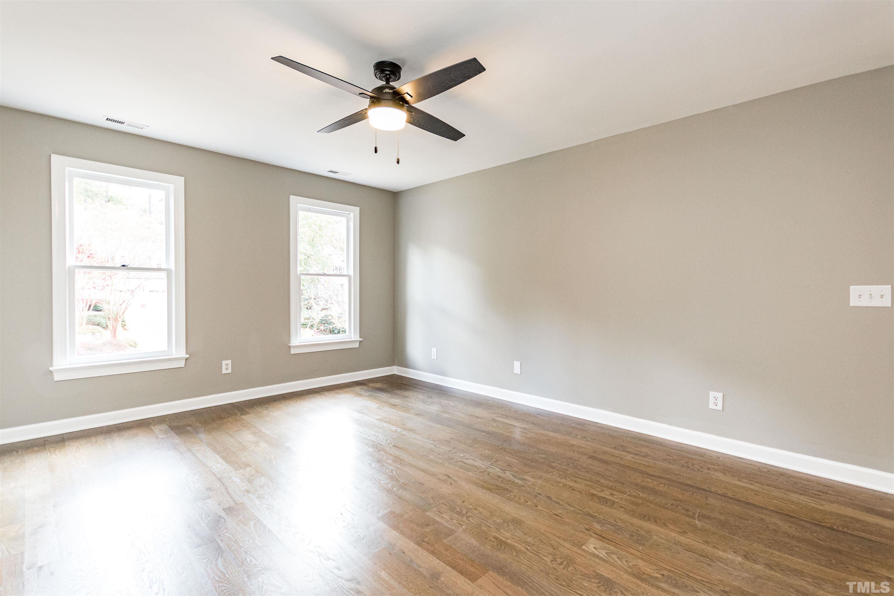 8105 Laurel Mountain Road Raleigh, NC 27613 - Photo 13 of 26 a view of an empty room with wooden floor and a window