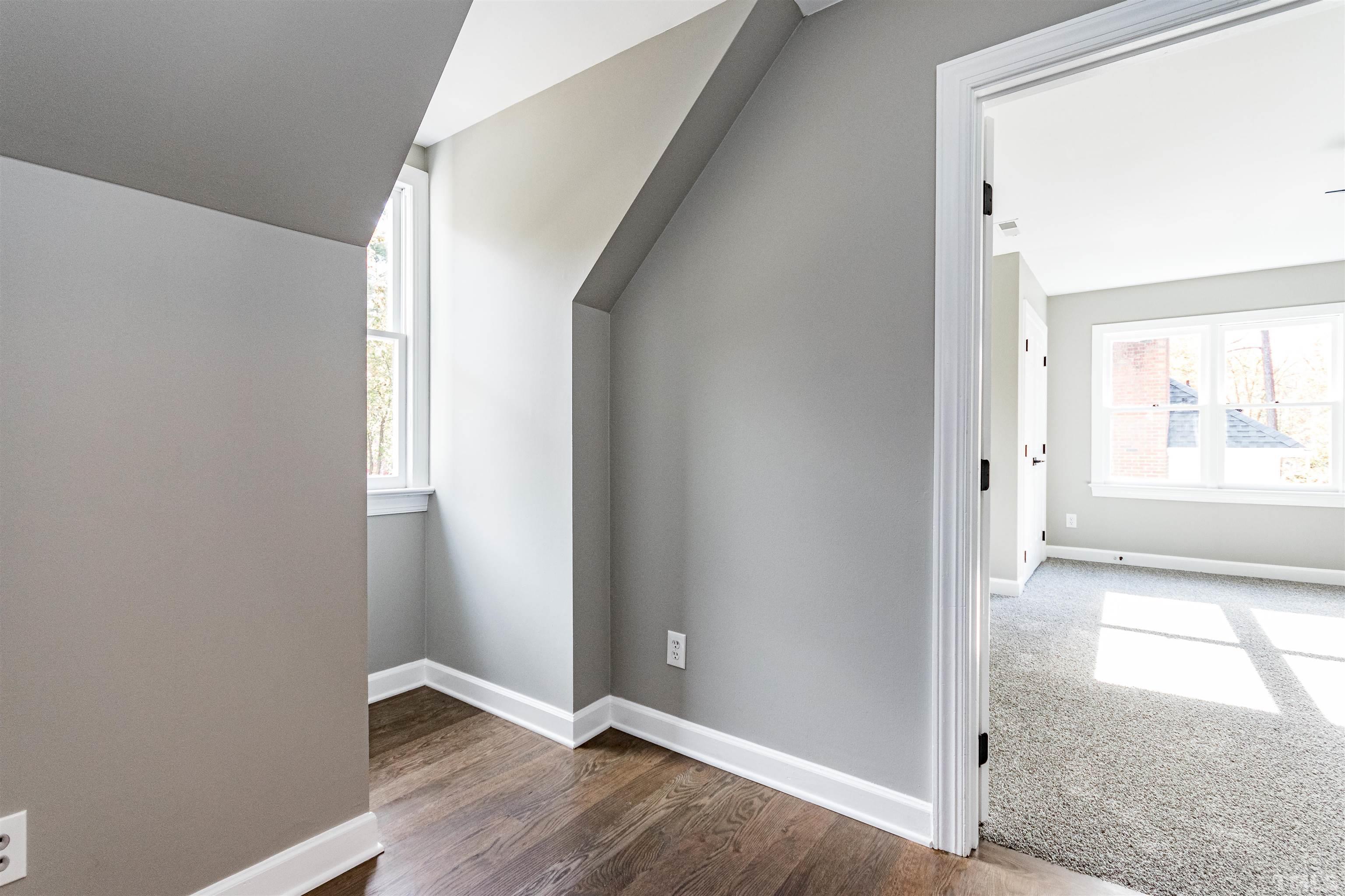 8105 Laurel Mountain Road Raleigh, NC 27613 - Photo 17 of 26 an empty room with wooden floor and windows