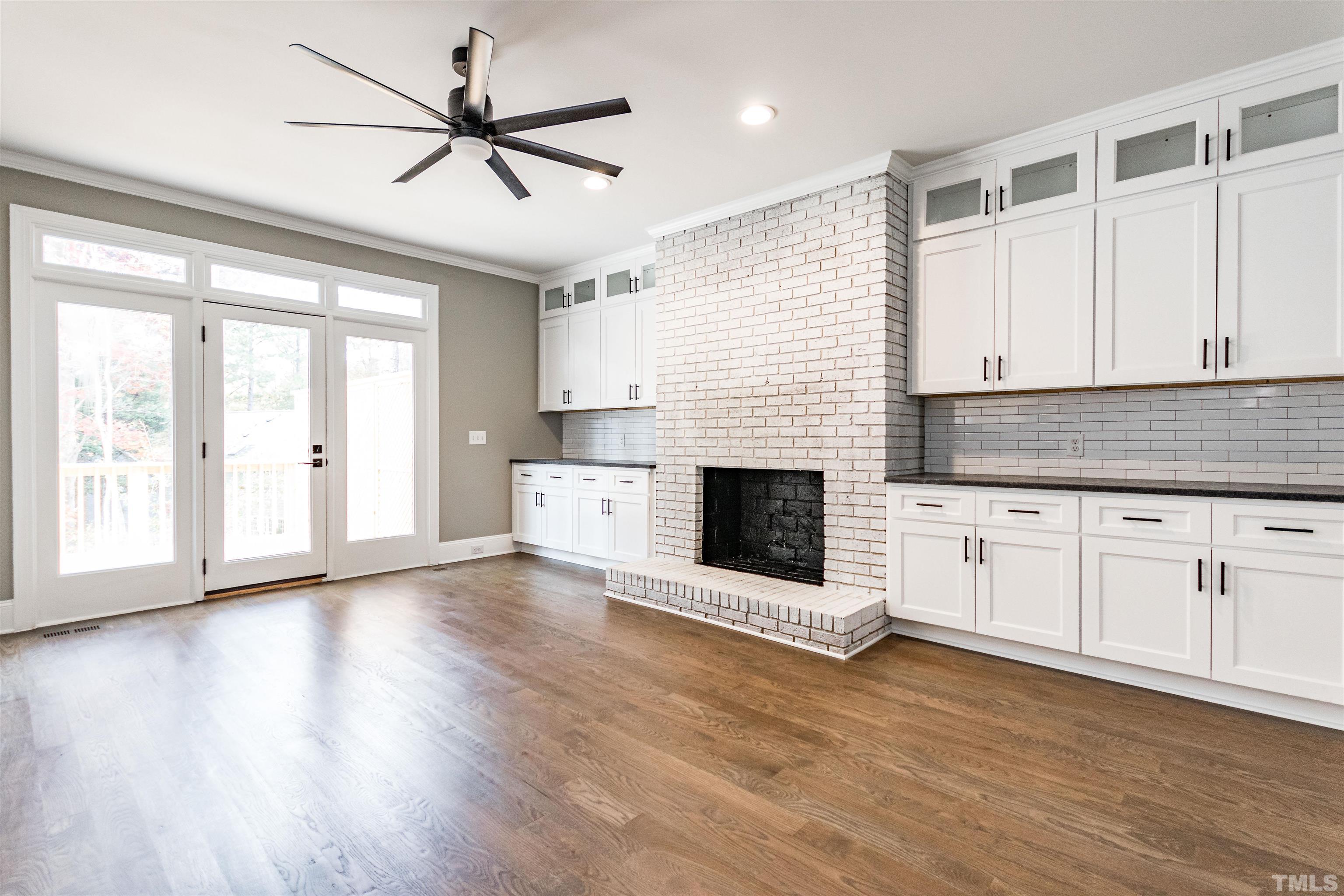 8105 Laurel Mountain Road Raleigh, NC 27613 - Photo 3 of 26 a view of a kitchen with microwave and wooden floor