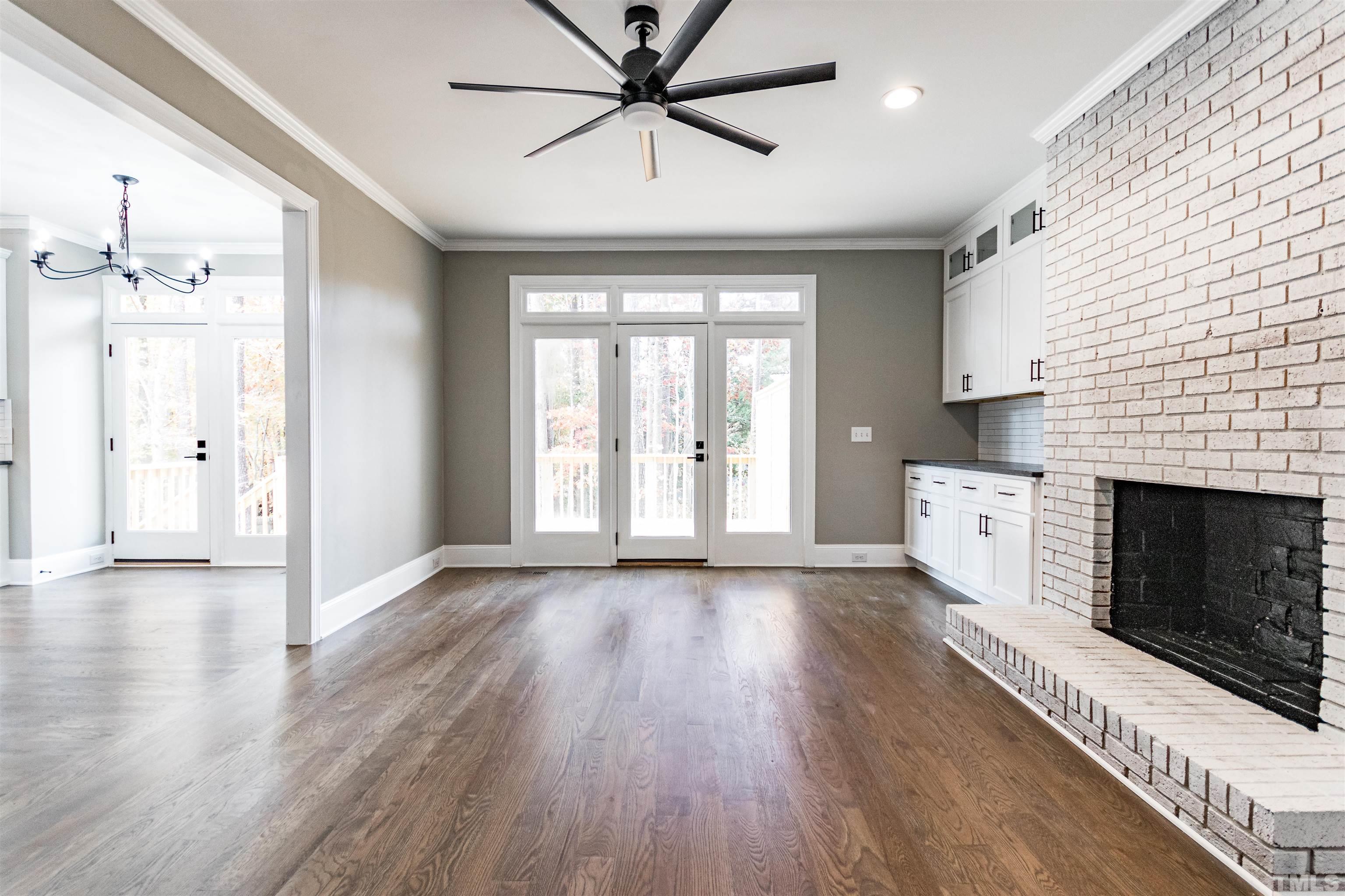 8105 Laurel Mountain Road Raleigh, NC 27613 - Photo 4 of 26 a view of a livingroom with wooden floor and a kitchen space