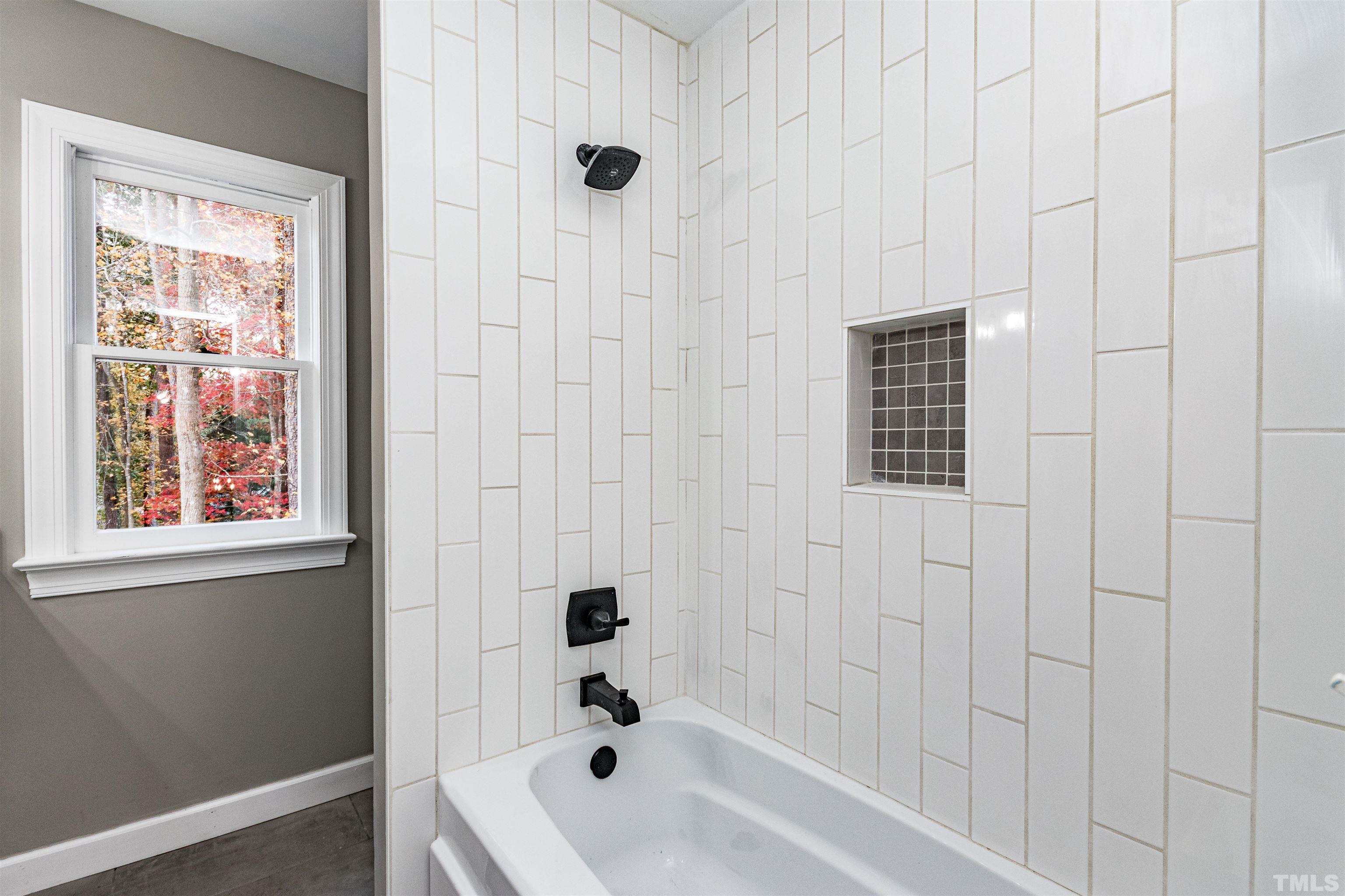 8105 Laurel Mountain Road Raleigh, NC 27613 - Photo 10 of 26 a bathroom with a bathtub and shower