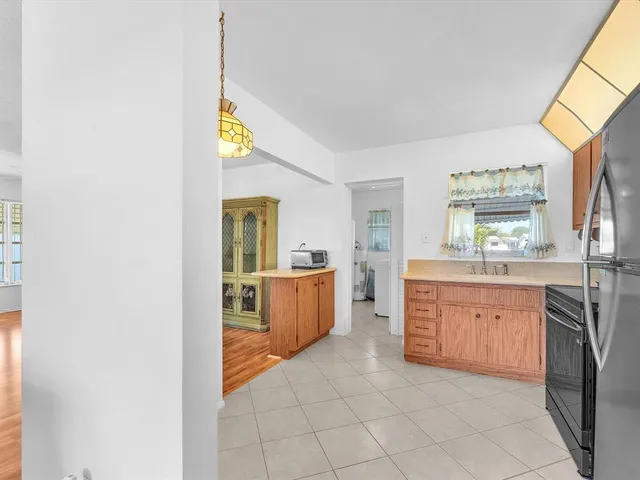 a large kitchen with a stove a sink dishwasher and a refrigerator