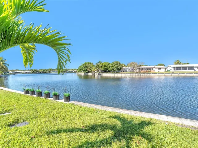 a view of a lake with houses in the background