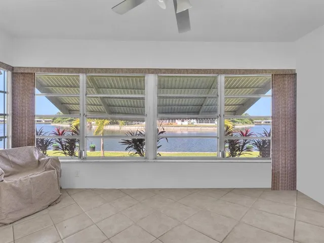 an outdoor living room with a couch and next to a window