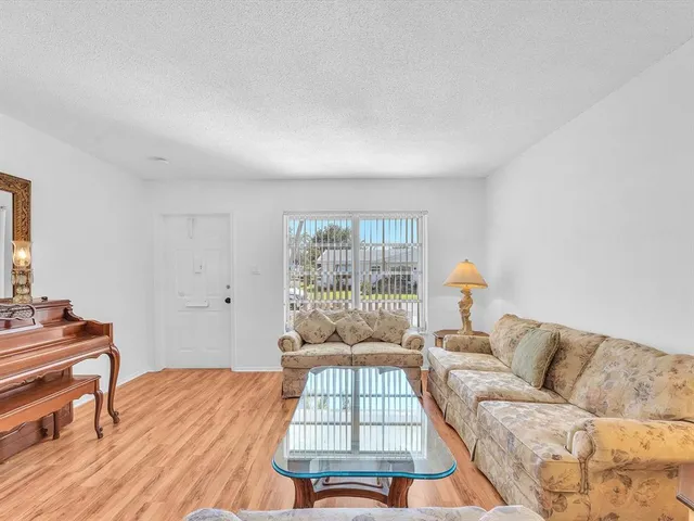 a living room with a bed furniture and a large window