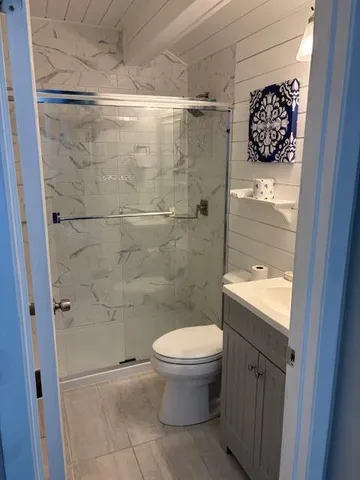 a bathroom with a toilet and a shower