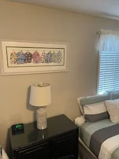 a bedroom with a bed and lamp