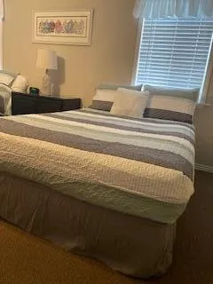 a bedroom with two beds and painting on the wall