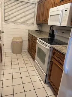 a kitchen with a stove a sink and a microwave