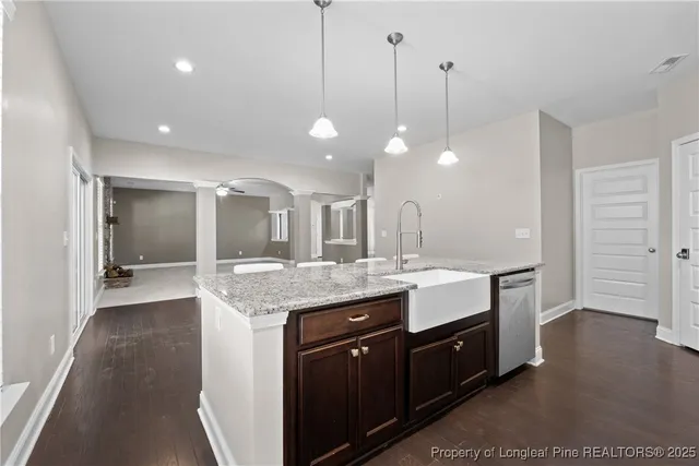 a bathroom with a granite countertop sink a large mirror and a shower