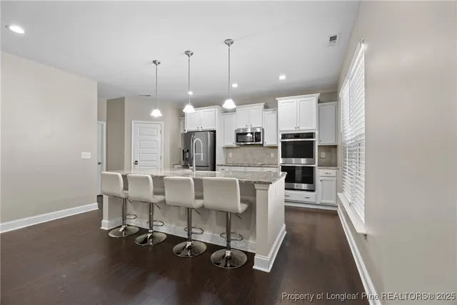 a dining room with furniture and a chandelier