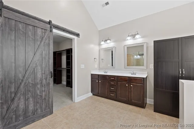 a spacious bathroom with a double vanity sink and a mirror