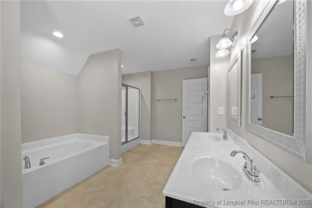 a bathroom with a bathtub and a sink
