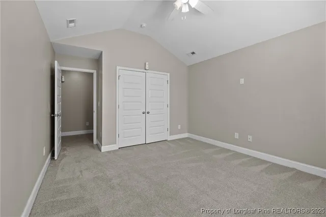 an empty room with a ceiling fan