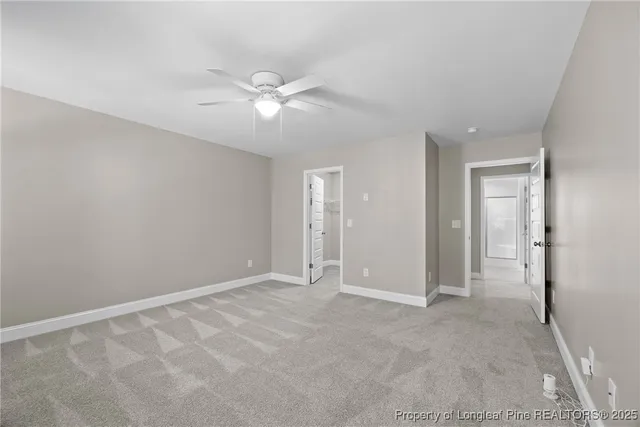 a view of an empty room with a ceiling fan