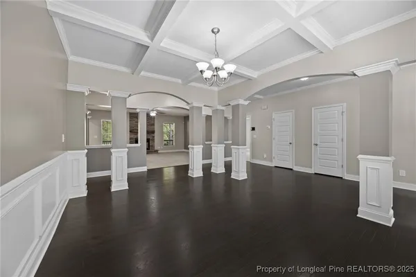 a view of an empty room with a fireplace and a window