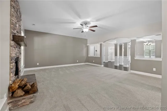 a view of a livingroom with a ceiling fan and window