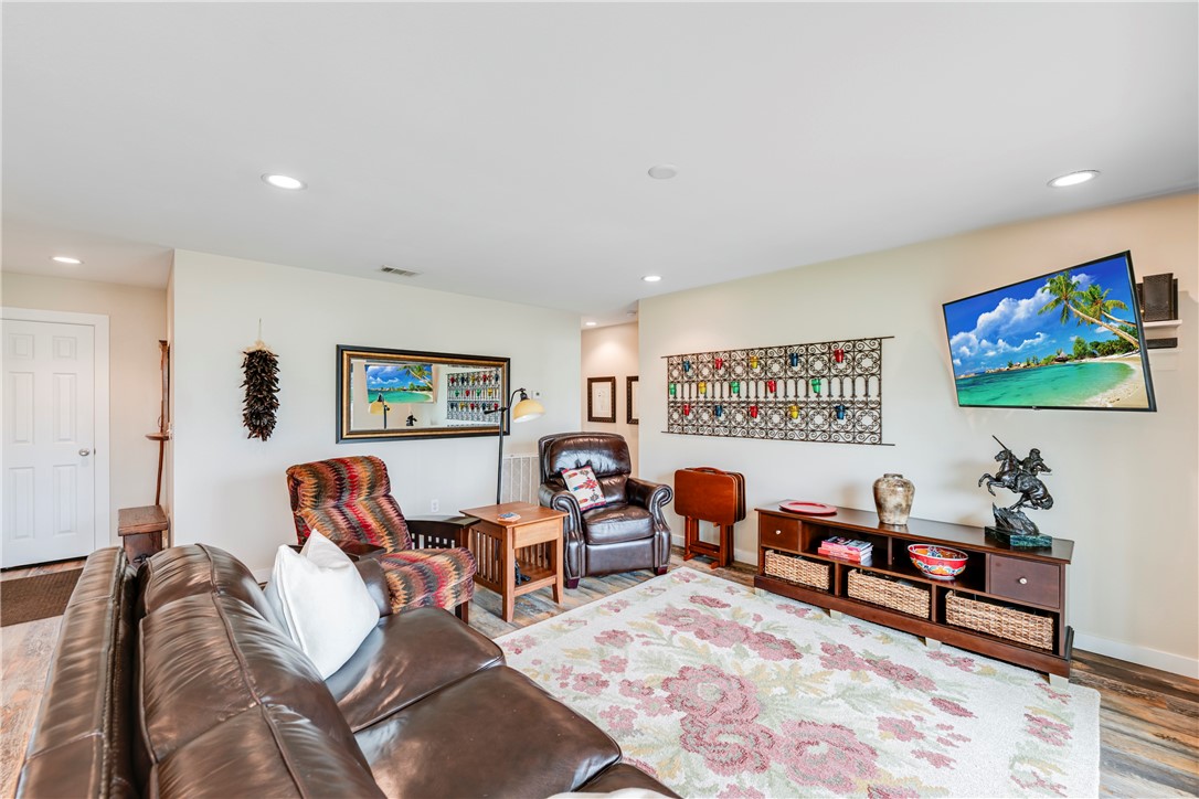230 Cut-Off Road, Unit 101 Port Aransas, TX 78373 - Photo 5 of 30 a living room with furniture and a flat screen tv