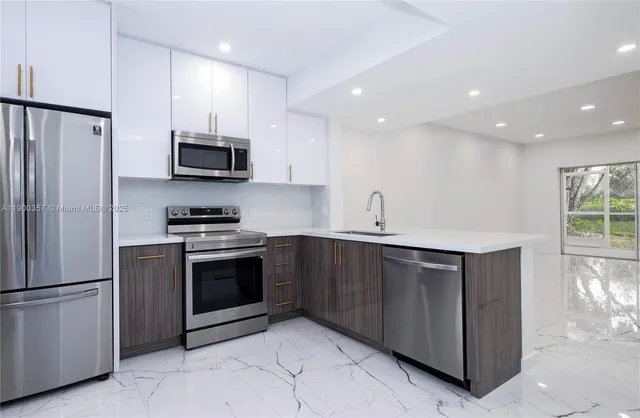 a kitchen with stainless steel appliances a refrigerator stove and microwave