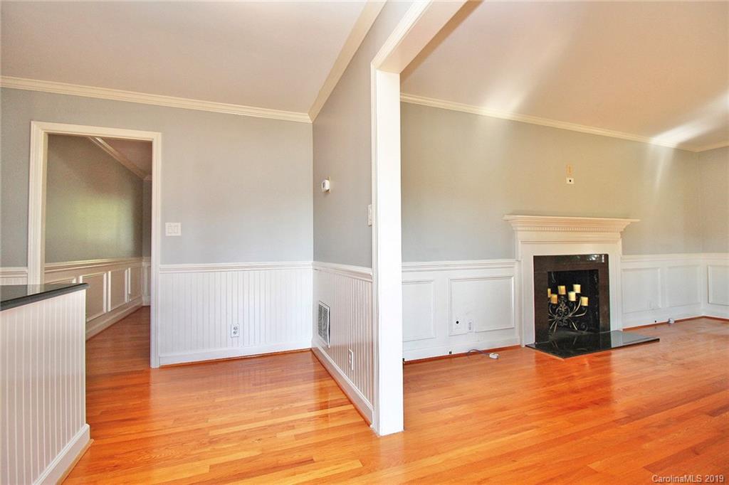 3399 Pleasant Road Fort Mill, SC 29708 - Photo 14 of 48 an empty room with wooden floor and a fireplace