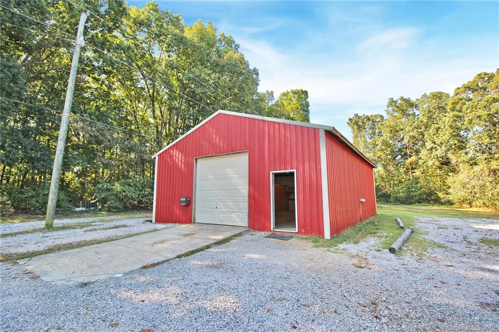 3399 Pleasant Road Fort Mill, SC 29708 - Photo 33 of 48 a view of a barn in a yard with large trees