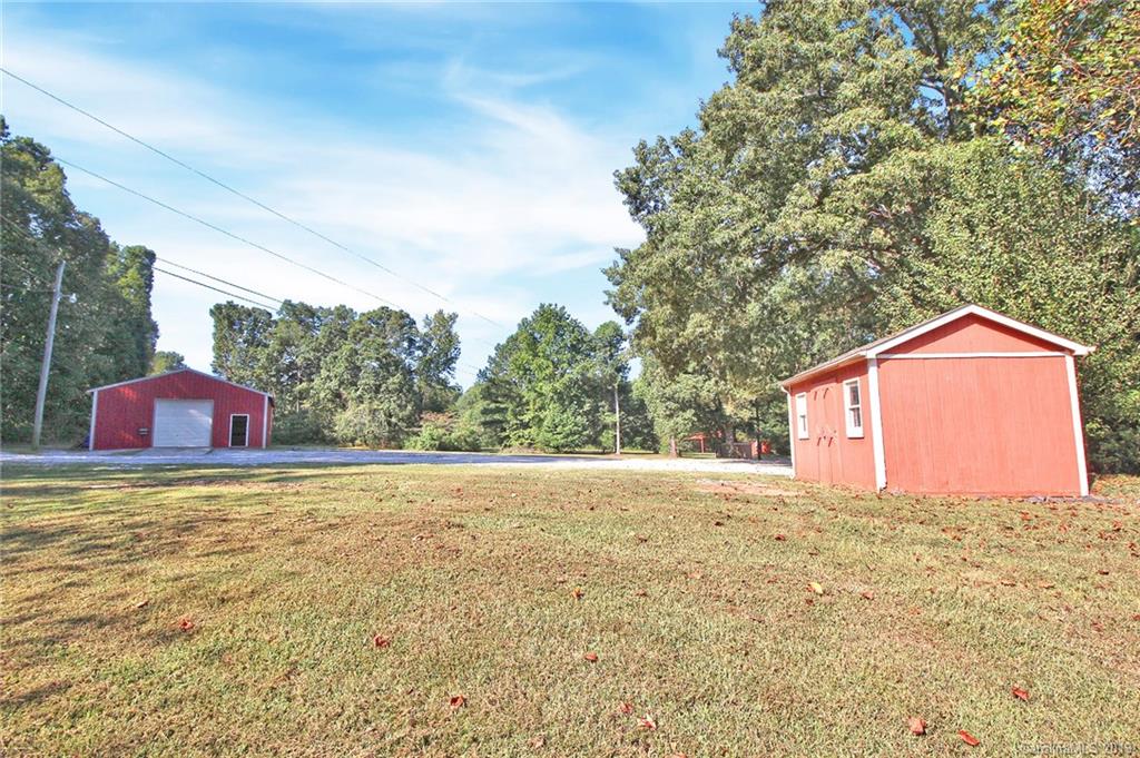 3399 Pleasant Road Fort Mill, SC 29708 - Photo 34 of 48 a backyard of a house with lots of green space and outdoor seating