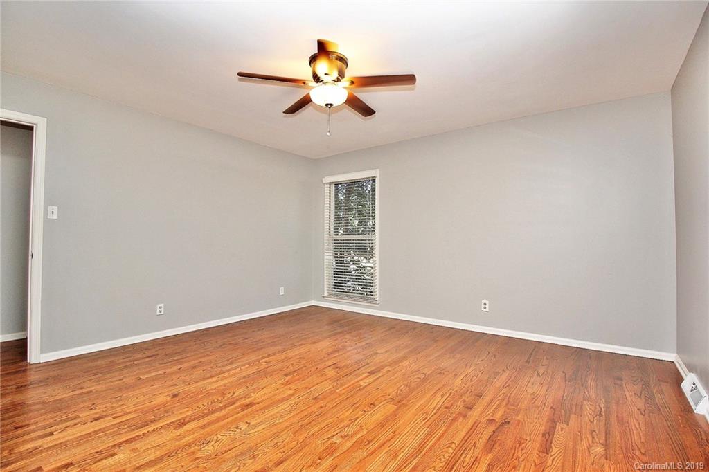 3399 Pleasant Road Fort Mill, SC 29708 - Photo 41 of 48 a view of an empty room with wooden floor and a ceiling fan