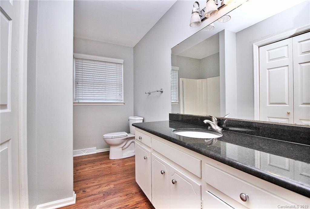 3399 Pleasant Road Fort Mill, SC 29708 - Photo 42 of 48 a bathroom with a granite countertop toilet a sink and a mirror