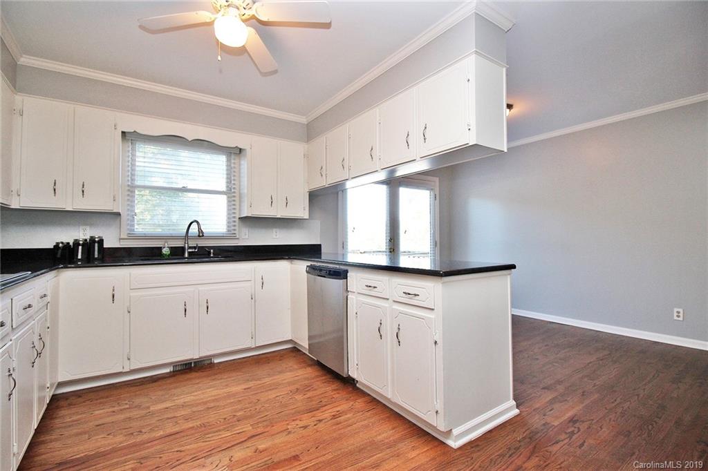 3399 Pleasant Road Fort Mill, SC 29708 - Photo 45 of 48 a kitchen with stainless steel appliances granite countertop white cabinets granite counter tops and a hard wood floors