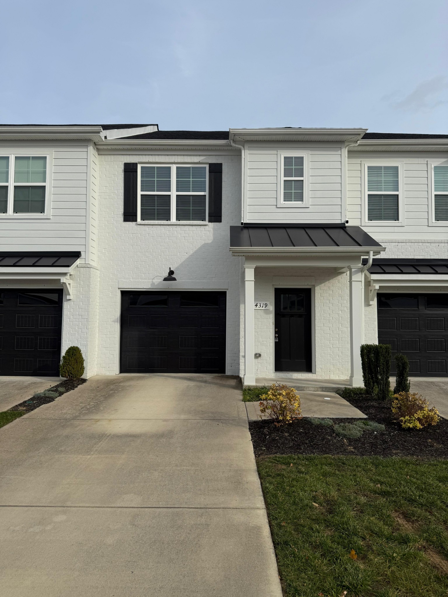 a view of a house with a yard and a garage