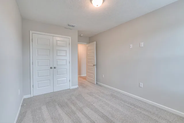 an empty room with closet area