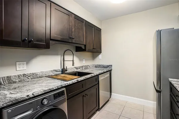 a kitchen with granite countertop stainless steel appliances and wooden cabinets