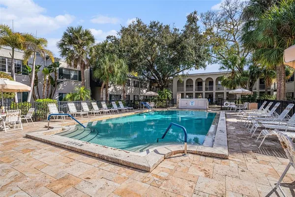 a view of a house with backyard porch and sitting area