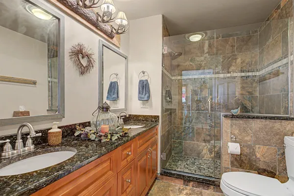 a spacious bedroom with a bed and a shower