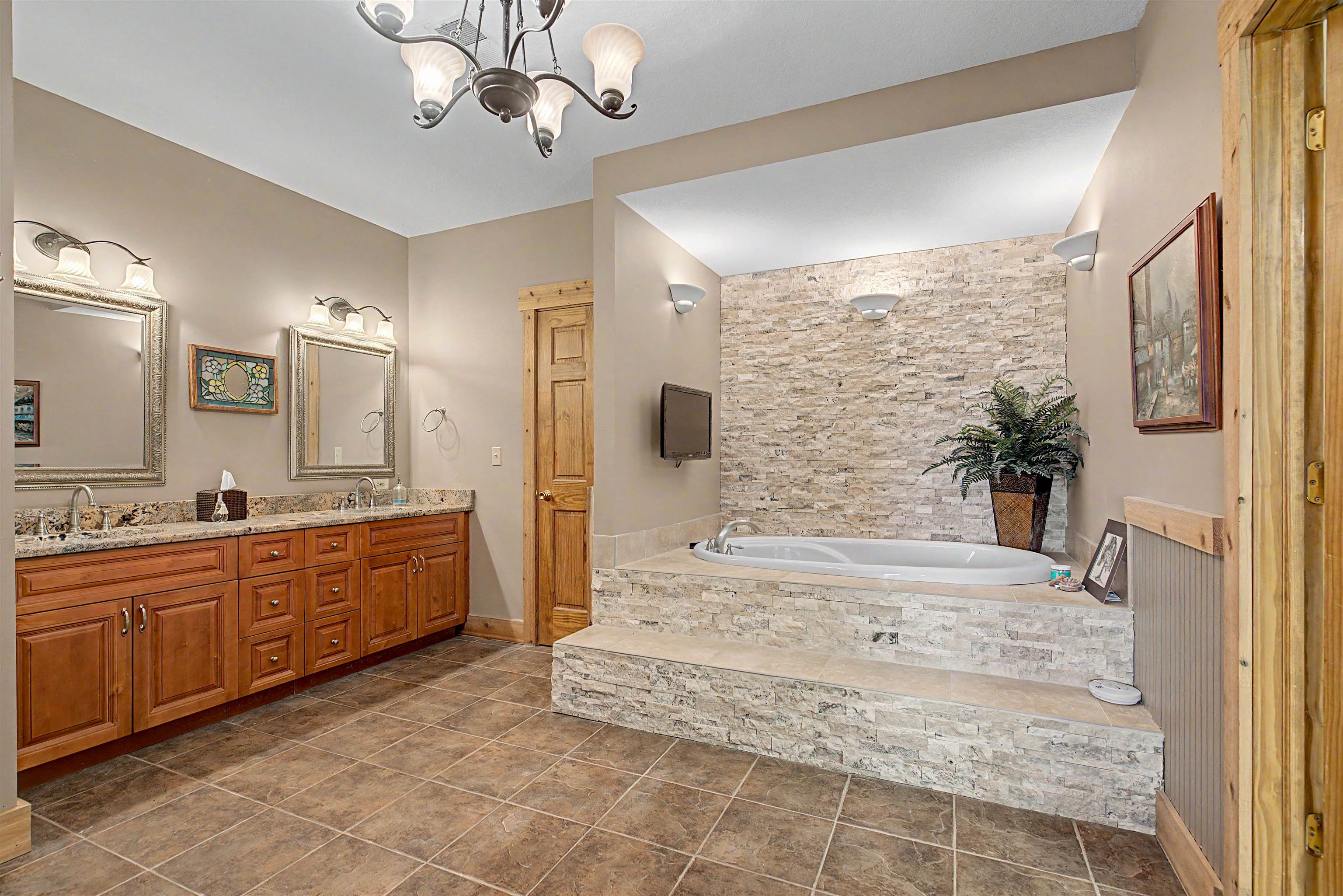 2287 West Hanover Road Hanover, IL 61041 - Photo 24 of 65 a large bathroom with a tub sink and mirror