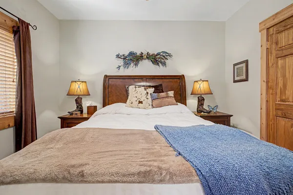 a bedroom with a bed and a chandelier