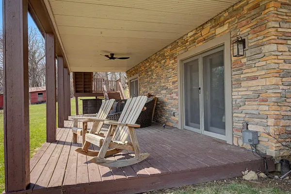 a balcony with wooden floor table and chairs