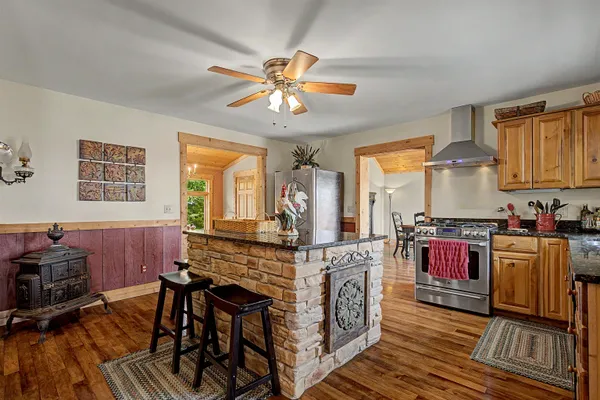 a kitchen with stainless steel appliances granite countertop a stove and cabinets
