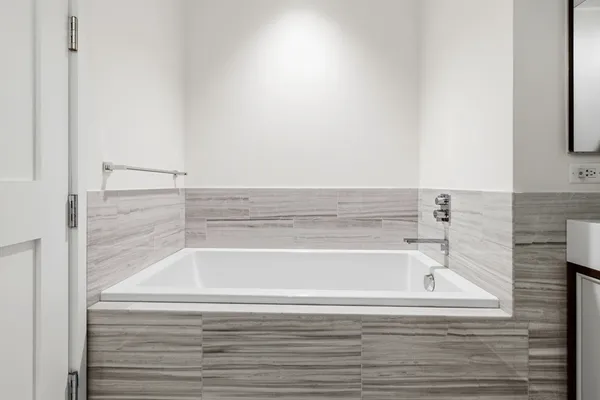 a vase of flowers sitting on a table with a mirror